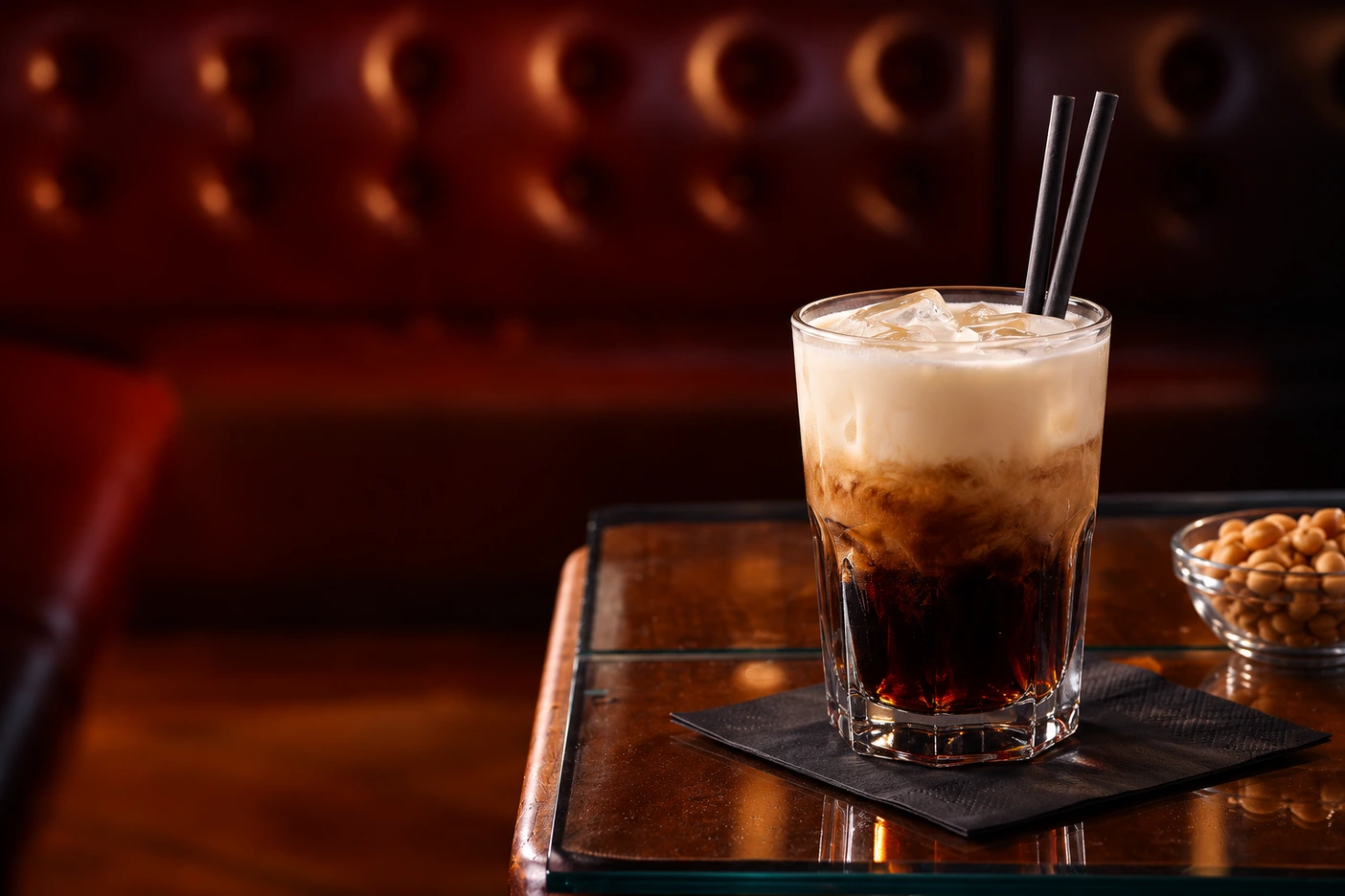 White Russian mit Kaffee-Likör, cremigem Obers und schwarzen Papierstrohhalmen im MABEL’S